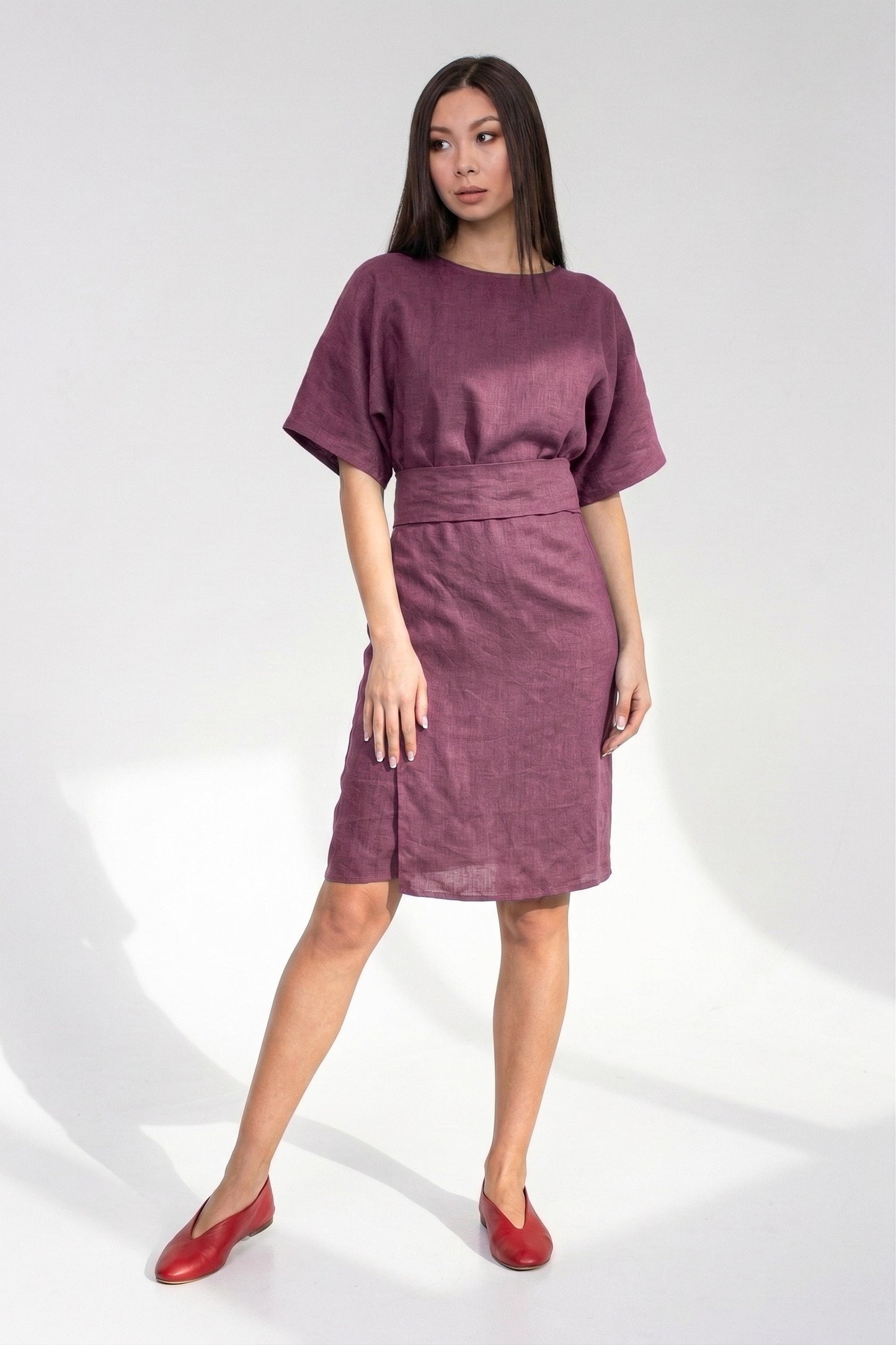 Woman wearing a purple dress on a white background