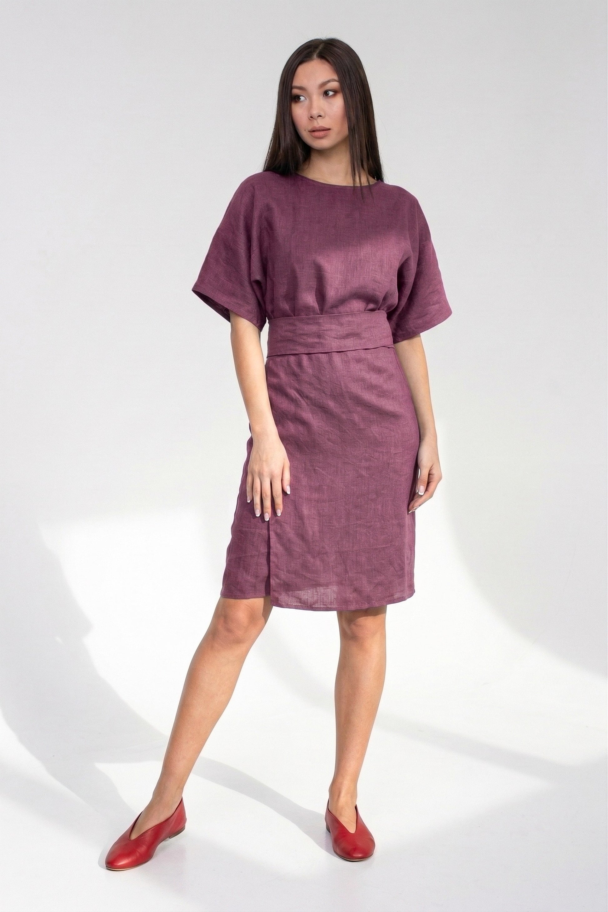 Woman wearing a purple dress on a white background