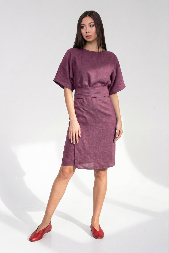 Woman wearing a purple dress on a white background