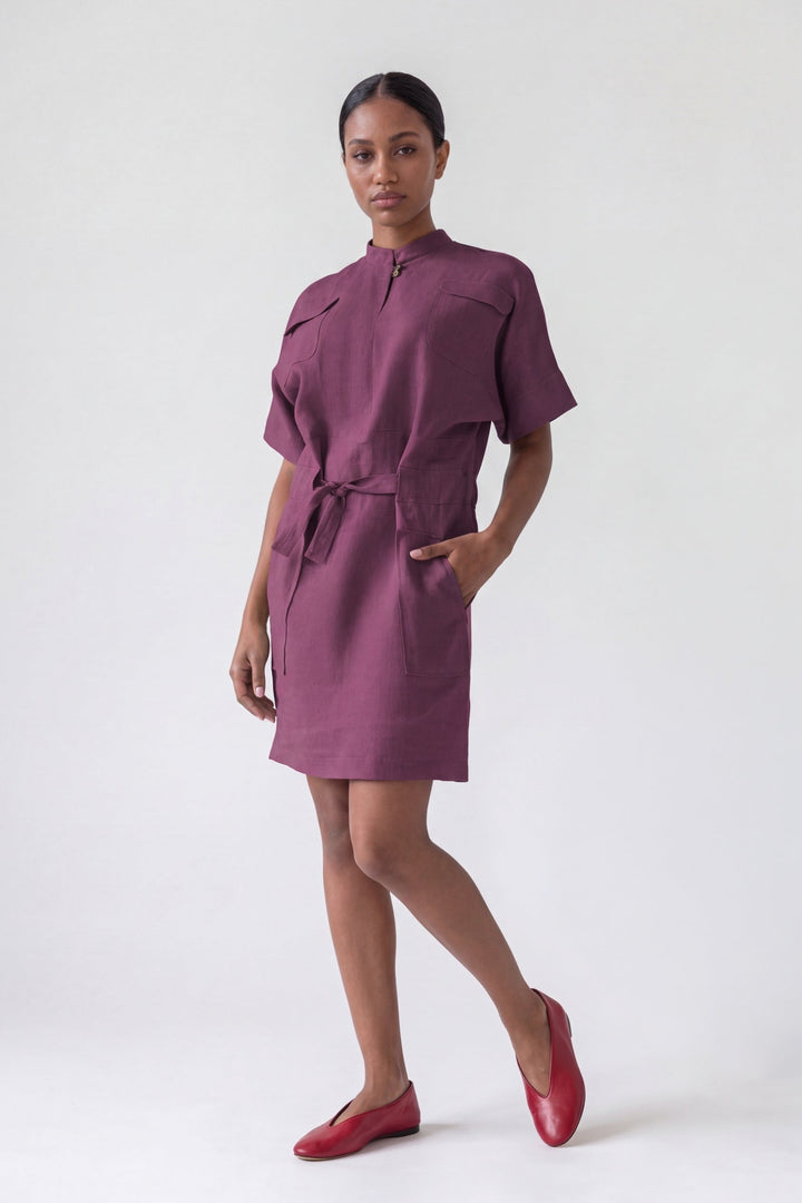 Woman wearing a purple dress with a white background